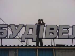 Вывеска "Будівельник"на крыше здания